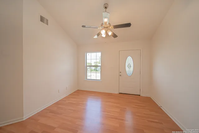 wooden floor in an empty room with a window