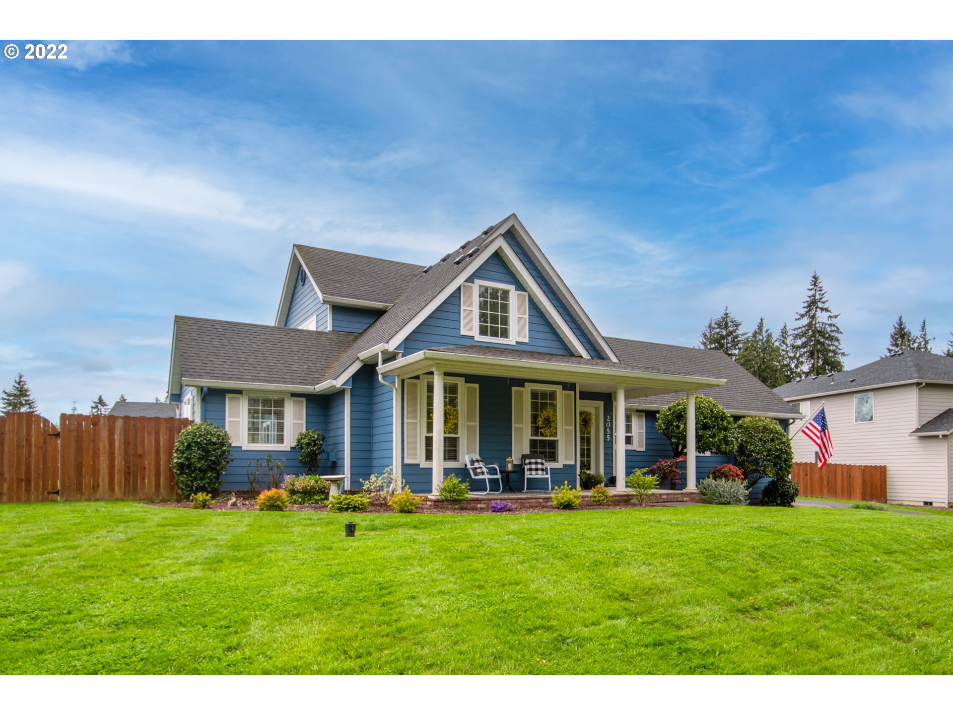 2055 South Sevier Road Ridgefield, WA 98642 - Photo 1 of 31 a front view of a house with a yard table and chairs