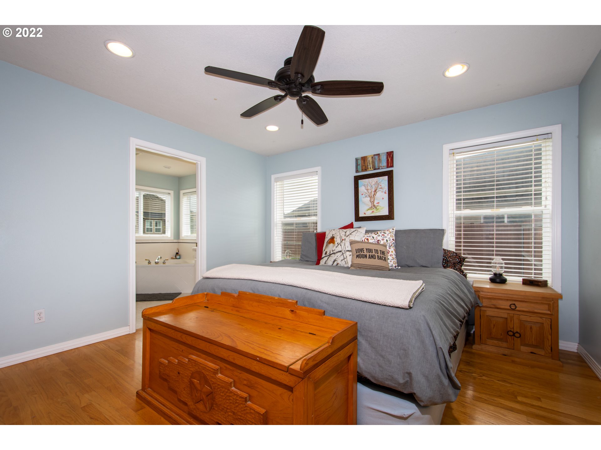 2055 South Sevier Road Ridgefield, WA 98642 - Photo 11 of 31 a bedroom with a bed and a chandelier