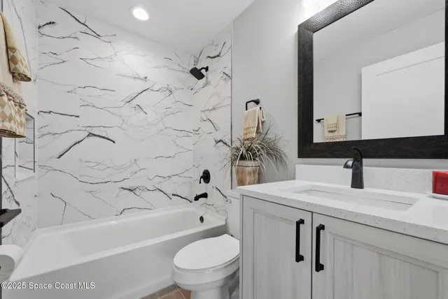 a view of an empty room with a window and a ceiling fan