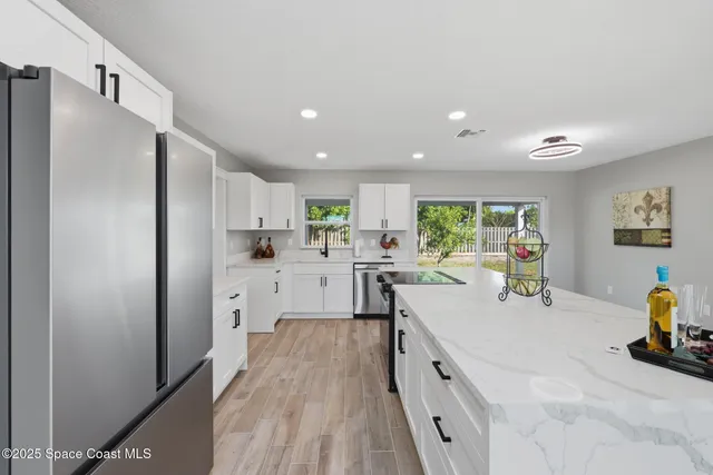 a kitchen with a sink appliances and cabinets
