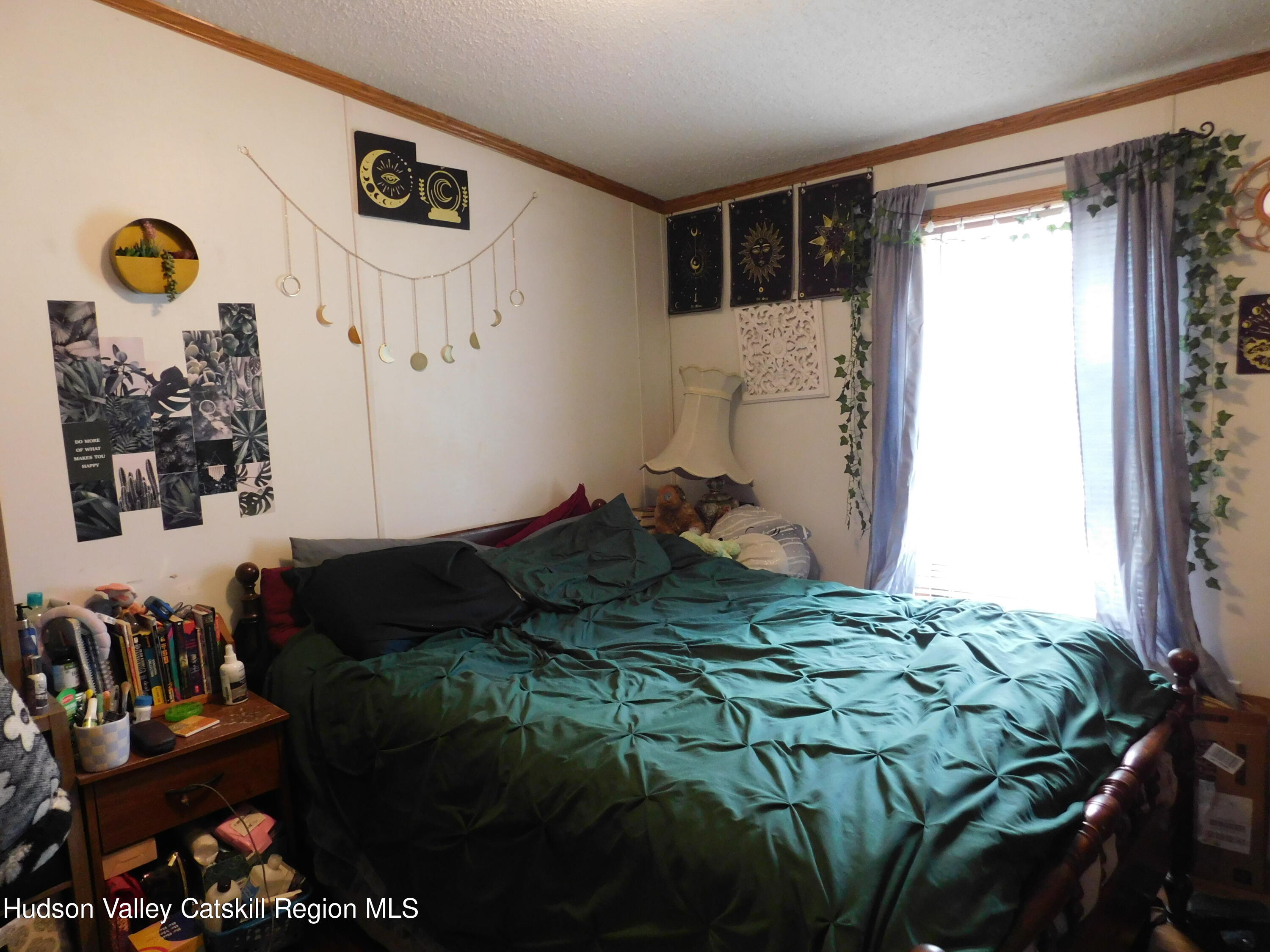 156 Lippman Road Hurleyville, NY 12747 - Photo 12 of 22 a bedroom with a bed and a window