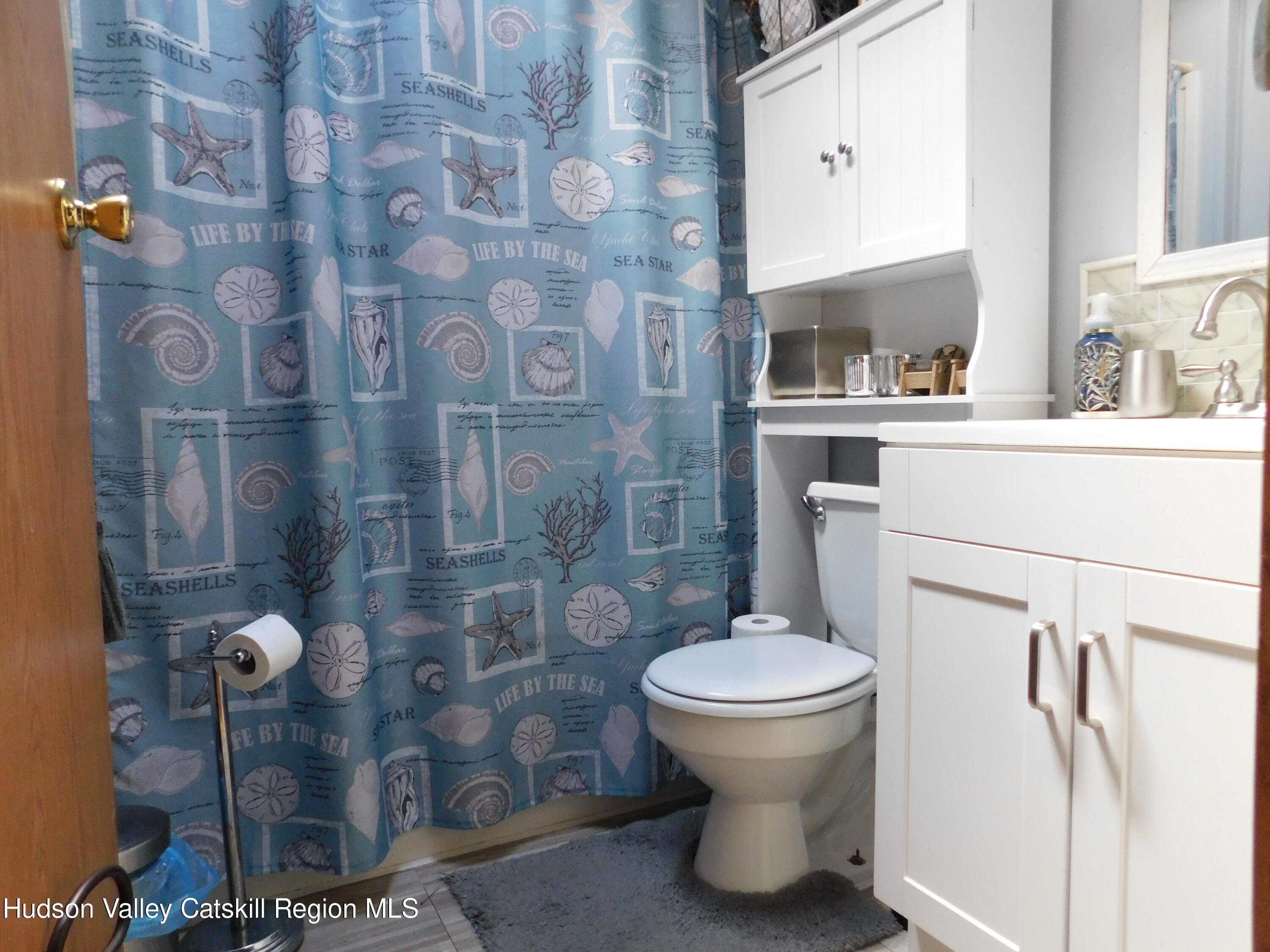 156 Lippman Road Hurleyville, NY 12747 - Photo 13 of 22 a bathroom with a sink toilet and shower