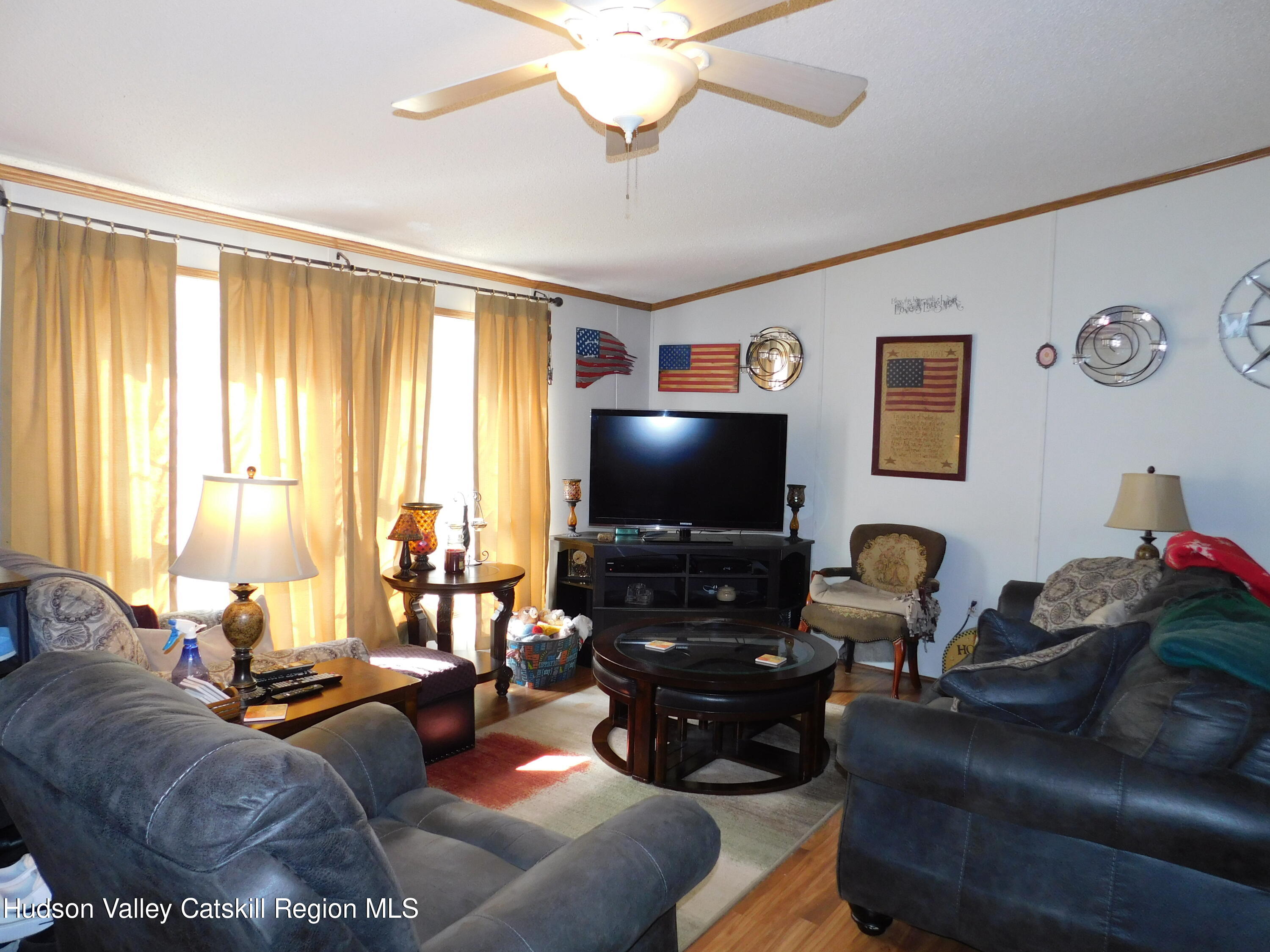 156 Lippman Road Hurleyville, NY 12747 - Photo 3 of 22 a living room with furniture and a flat screen tv