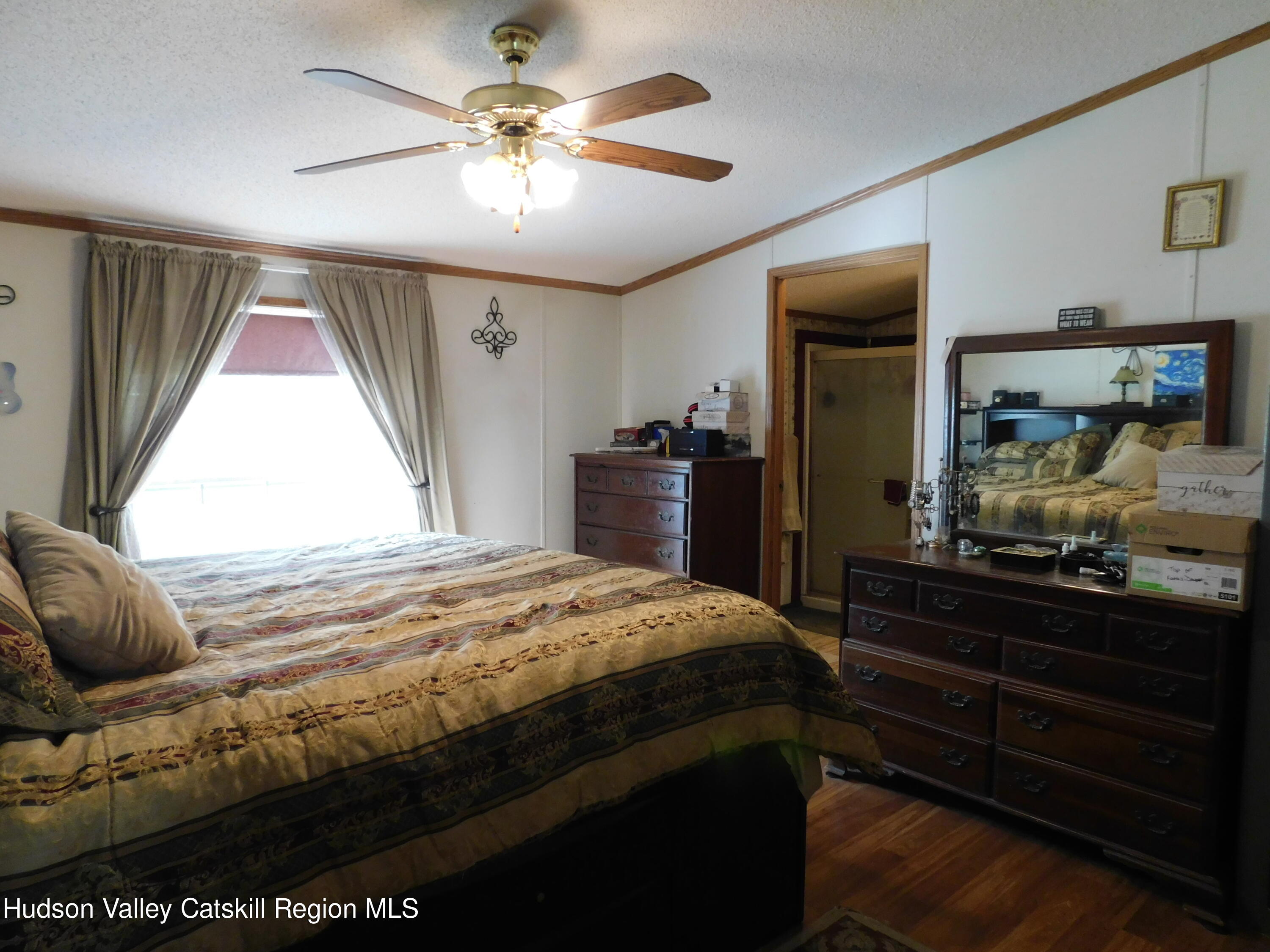 156 Lippman Road Hurleyville, NY 12747 - Photo 8 of 22 a bedroom with a bed and wooden floor