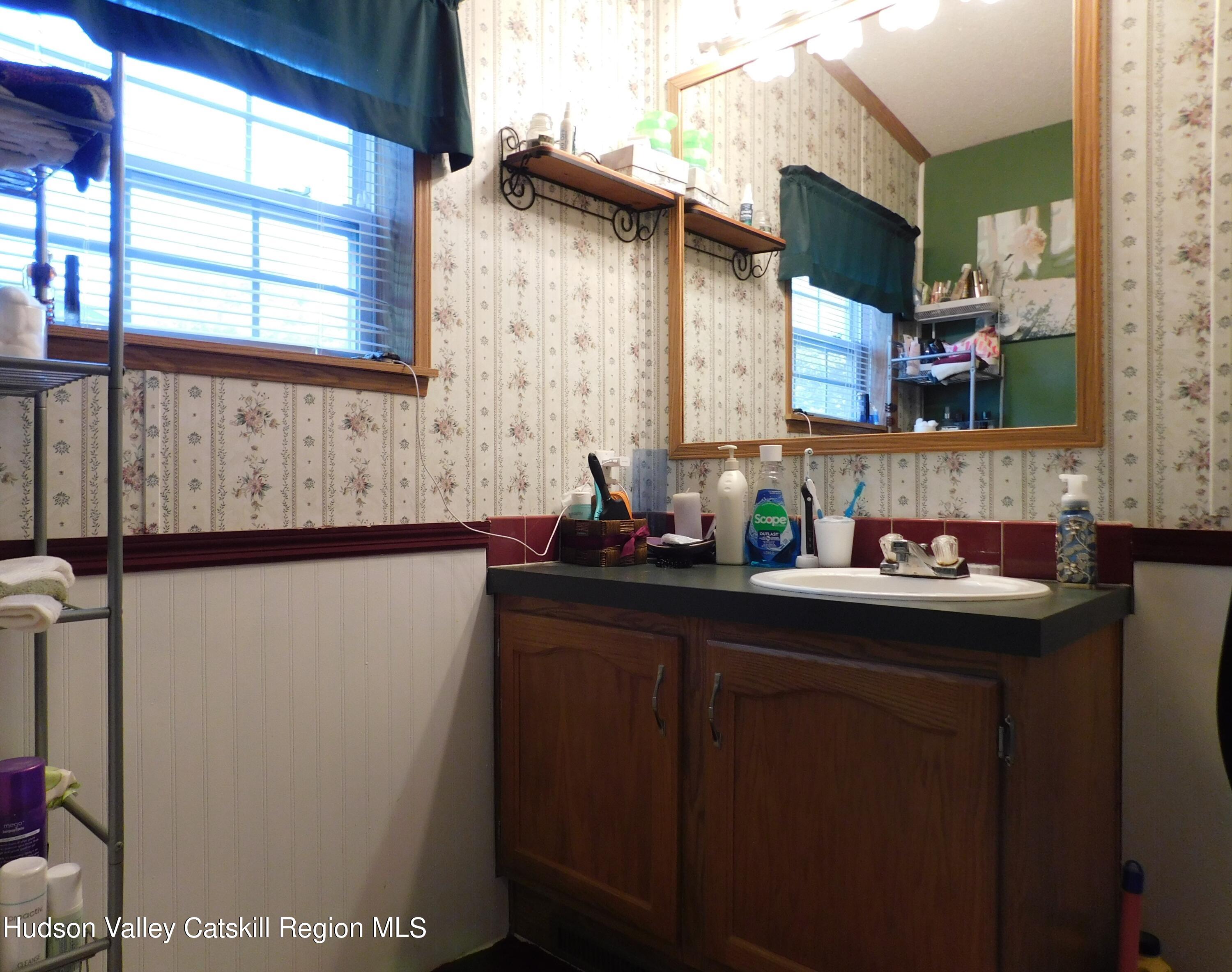 156 Lippman Road Hurleyville, NY 12747 - Photo 9 of 22 a bathroom with a sink and a mirror