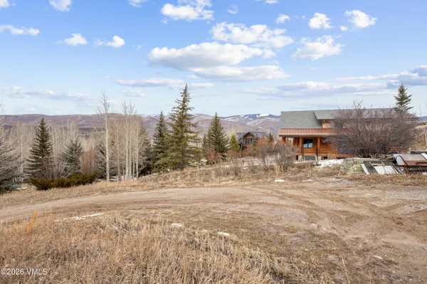 a view of a town with trees in the background