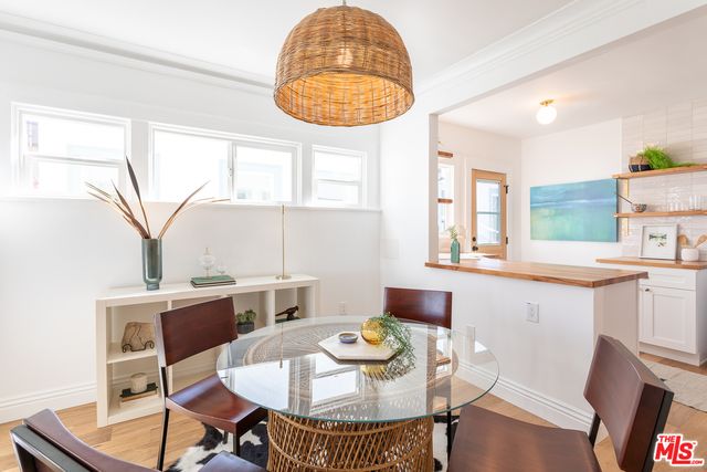a view of a dining room with furniture and a chandelier