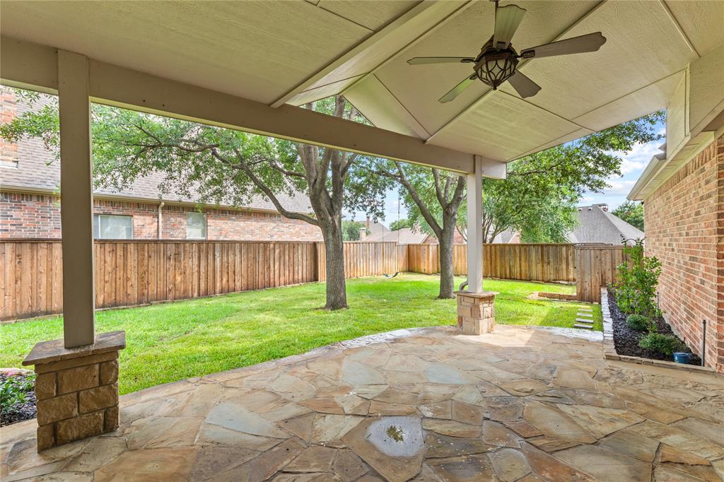 967 East Bethel School Road Coppell, TX 75019 - Photo 3 of 39 Covered patio featuring flagstone flooring, two stone-clad columns, and a ceiling fan