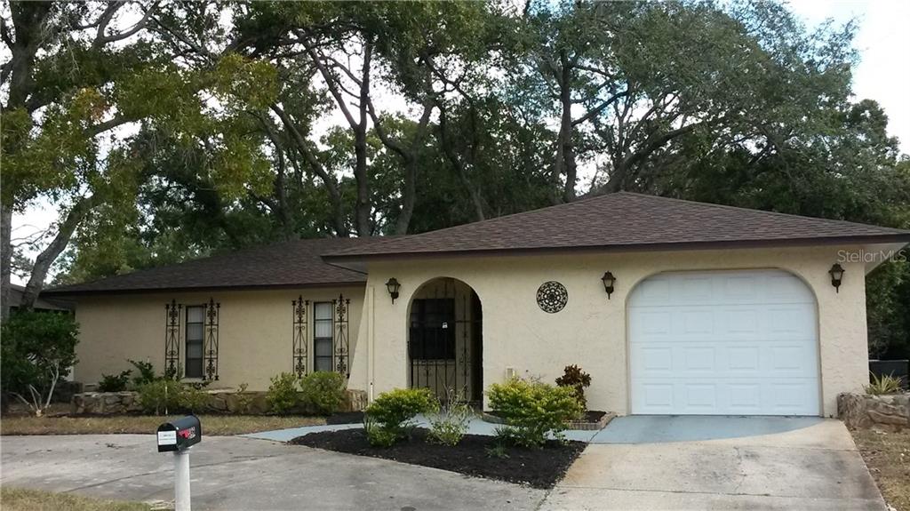 8934 Forest Lake Drive Port Richey, FL 34668 - Photo 1 of 1 a front view of a house with garden