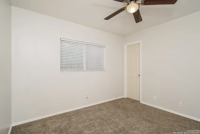 a view of a room with a ceiling fan