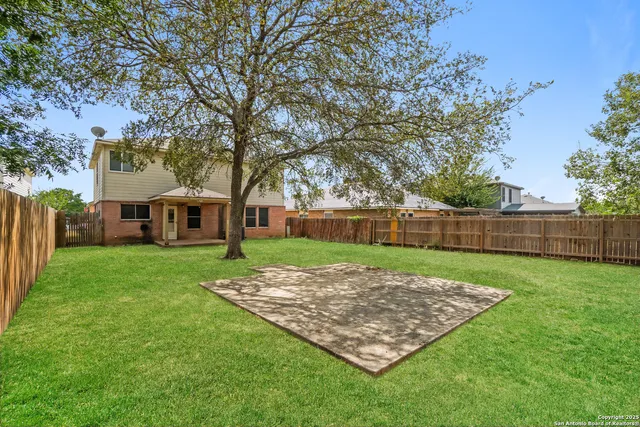 a view of a yard with a house in the background