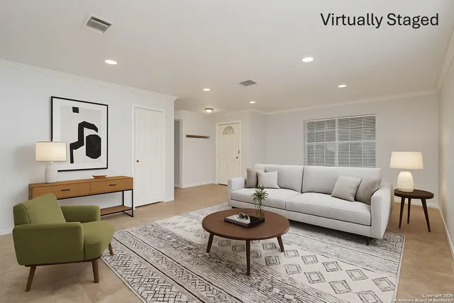 a living room with furniture a rug and a table