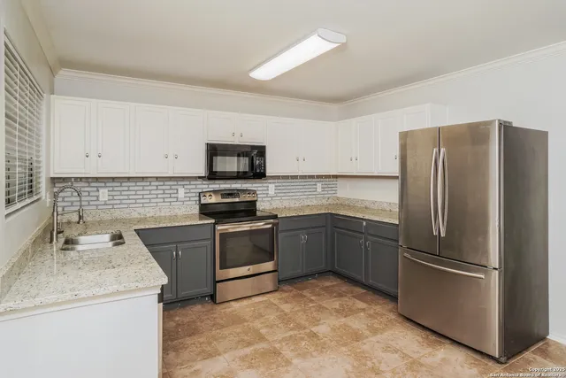 a kitchen with granite countertop stainless steel appliances and a sink