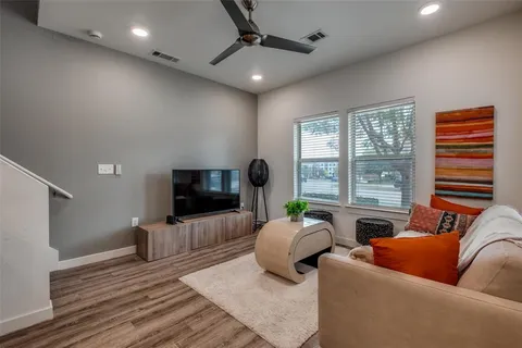 a kitchen with a sink cabinets and wooden floor