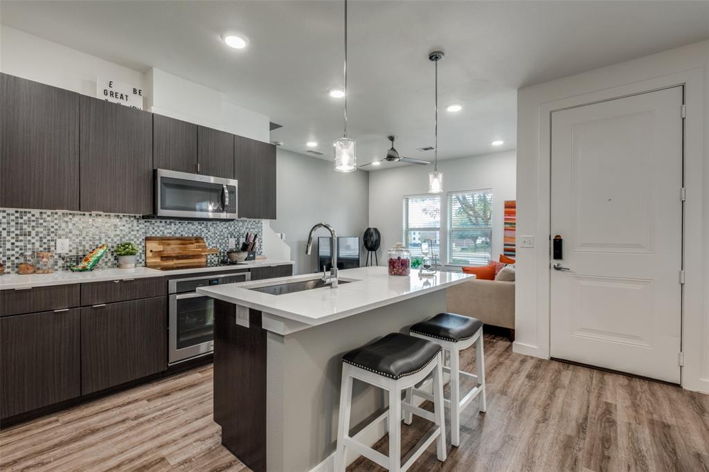 349 Tonga Street Dallas, TX 75203 - Photo 16 of 40 a kitchen with sink cabinets and wooden floor