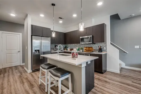 a bathroom with a granite countertop shower a mirror and a sink