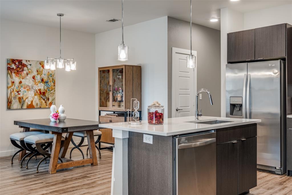 349 Tonga Street Dallas, TX 75203 - Photo 20 of 40 a kitchen with stainless steel appliances kitchen island granite countertop a sink refrigerator and cabinets
