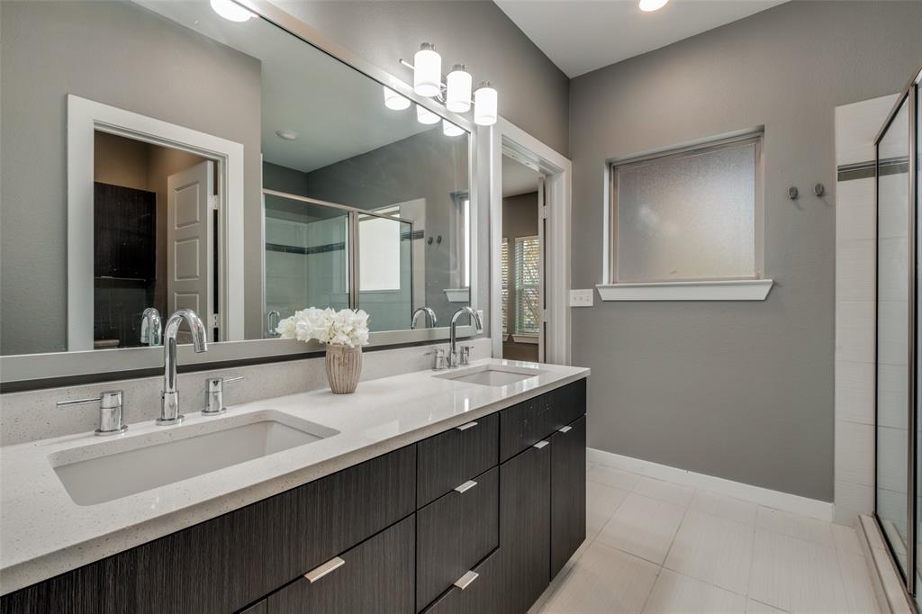 349 Tonga Street Dallas, TX 75203 - Photo 27 of 40 a bathroom with double vanity sinks and a mirror