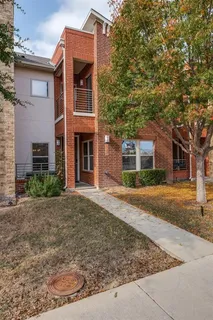 a kitchen with a table chairs a sink and dishwasher a refrigerator with wooden floor