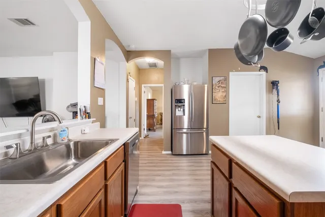 a very nice looking room with wooden floor and furniture