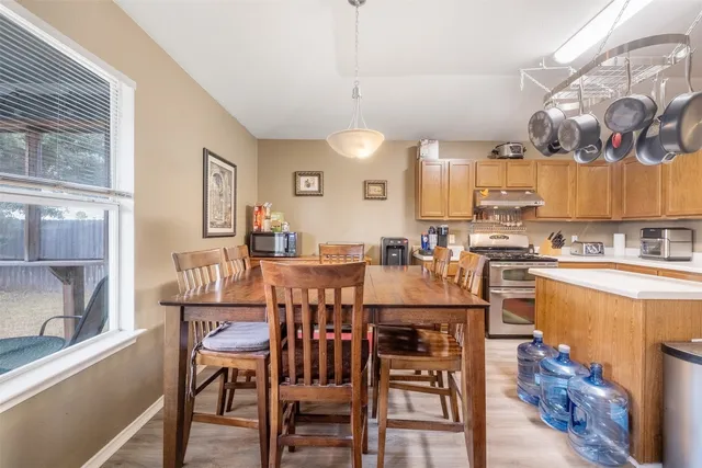 a kitchen that has a lot of cabinets a sink and a stove