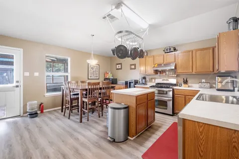 a kitchen with stainless steel appliances a sink stove and refrigerator