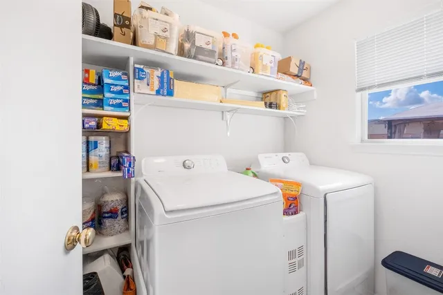 a bathroom with a granite countertop sink a toilet a mirror and shower