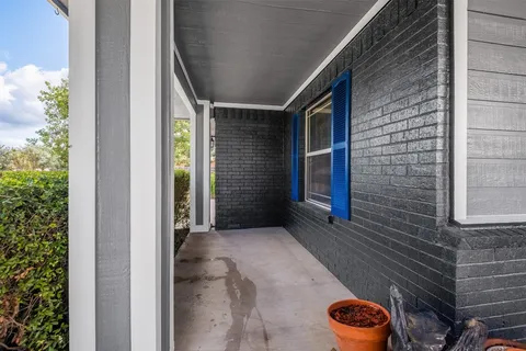 a view of a patio with a table and chairs and potted plants