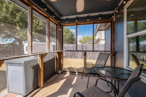 a view of a chair and table in the balcony