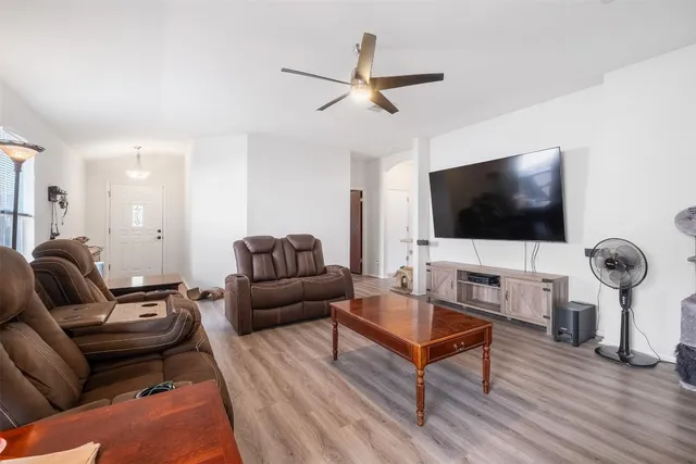 a living room with furniture and a flat screen tv