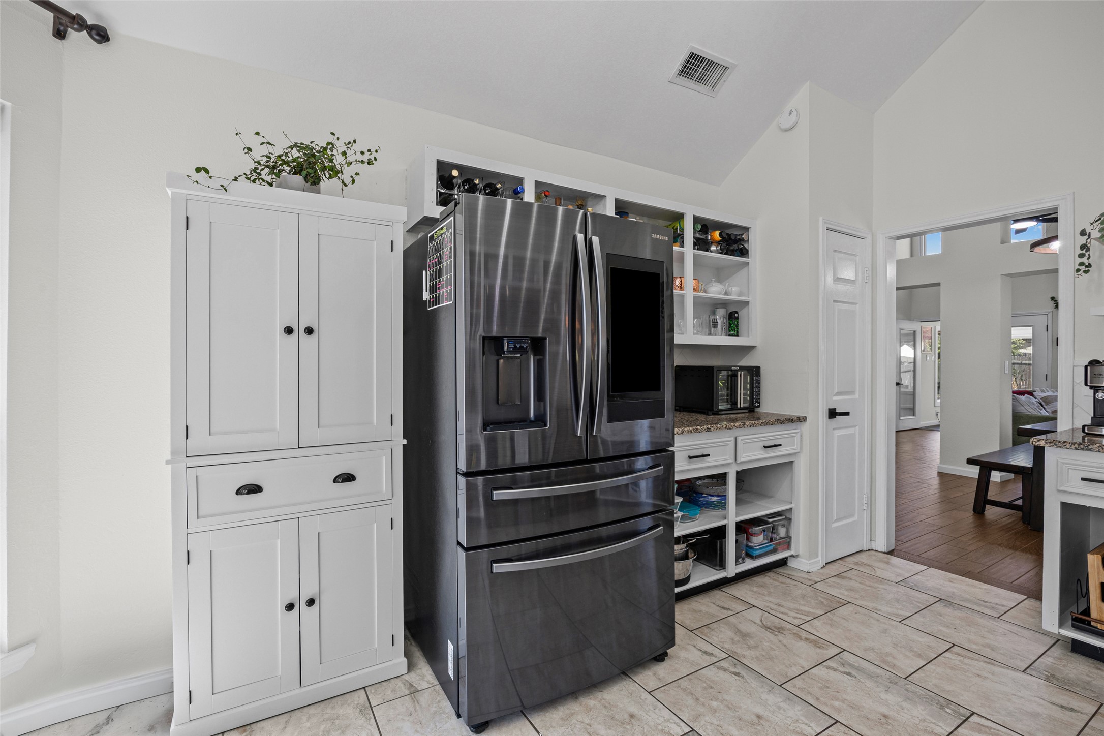 3006 Overland Street Round Rock, TX 78681 - Photo 9 of 29 Vaulted ceilings and tile flooring enhance this functional kitchen workspace.