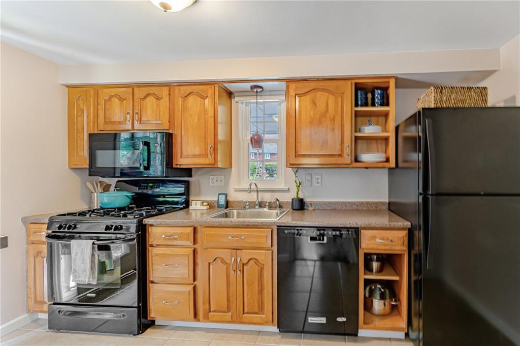 495 Old Farm Road Pittsburgh, PA 15228 - Photo 3 of 25 a kitchen with stainless steel appliances a stove and a refrigerator