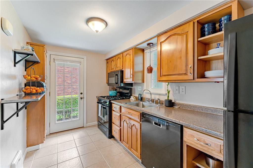 495 Old Farm Road Pittsburgh, PA 15228 - Photo 4 of 25 a kitchen with stainless steel appliances granite countertop a stove a sink and a microwave