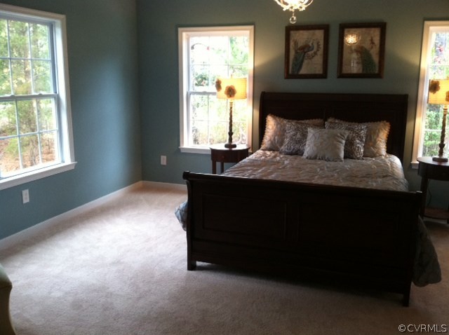 11400 Avening Road Midlothian, VA 23112 - Photo 8 of 10 a bed sitting in a bedroom next to a window