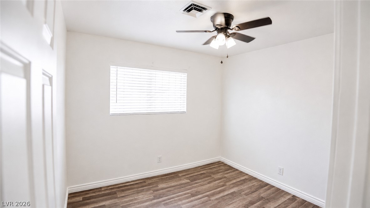 2870 South Sandhill Road Las Vegas, NV 89121 - Photo 36 of 64 A well-lit bedroom features durable hardwood flooring and a ceiling fan for comfort.