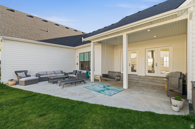 2013 South 100 West Perry, UT 84302 - Photo 36 of 49 Spacious concrete patio with a covered porch, white siding, multiple French doors, and a dark shingle roof