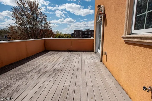 a view of balcony with wooden floor and fence