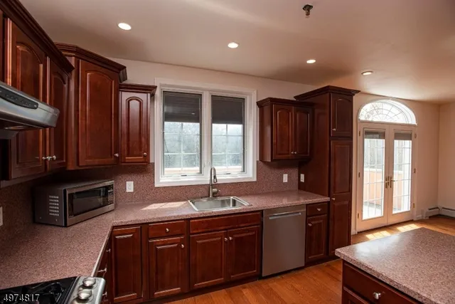 a kitchen with a sink and a stove top oven