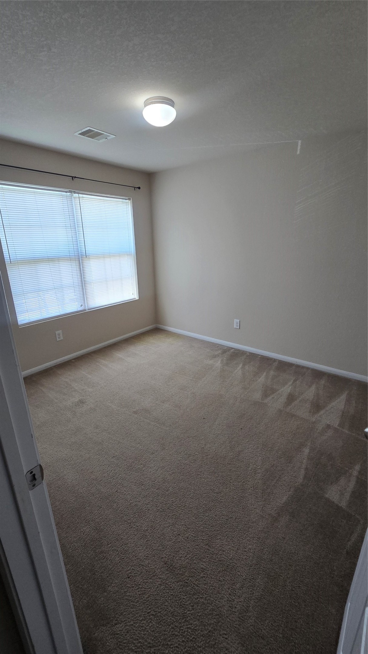 14819 Isle Of Pines Court Houston, TX 77049 - Photo 12 of 14 an empty room with a window