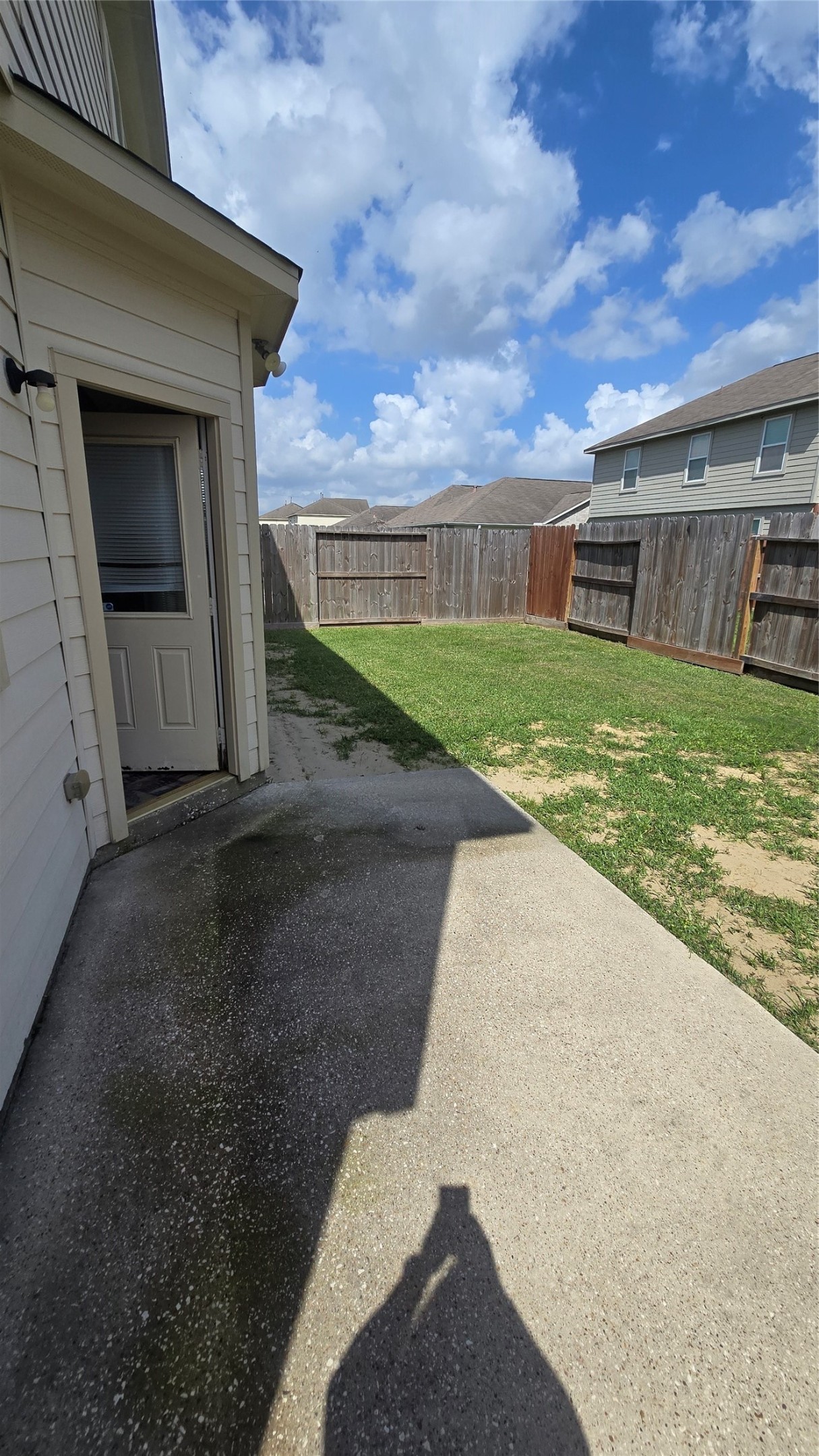14819 Isle Of Pines Court Houston, TX 77049 - Photo 14 of 14 a view of a backyard with brick wall and a large building