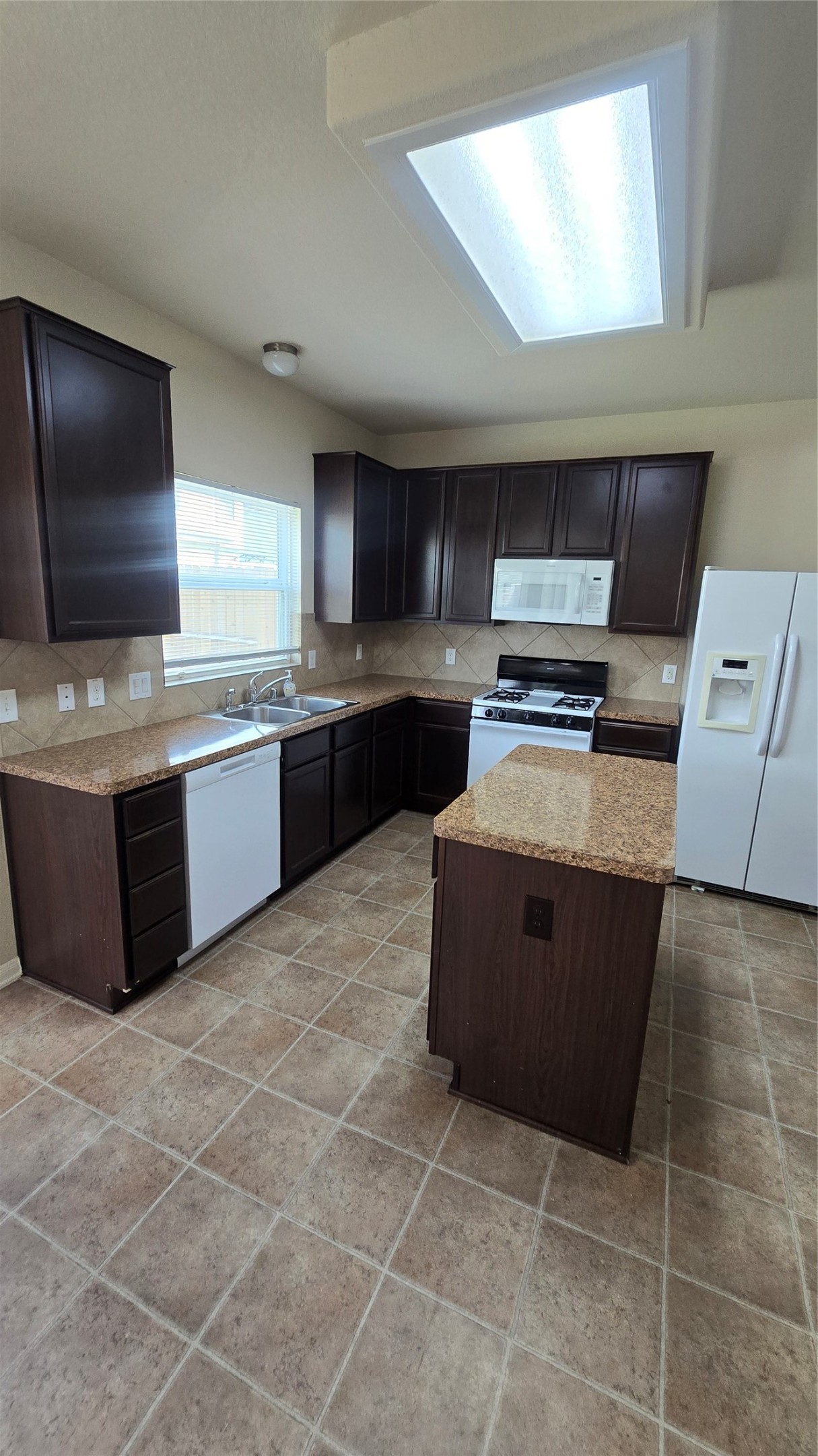14819 Isle Of Pines Court Houston, TX 77049 - Photo 6 of 14 a kitchen with stainless steel appliances granite countertop a stove top oven a sink a counter top space and cabinets