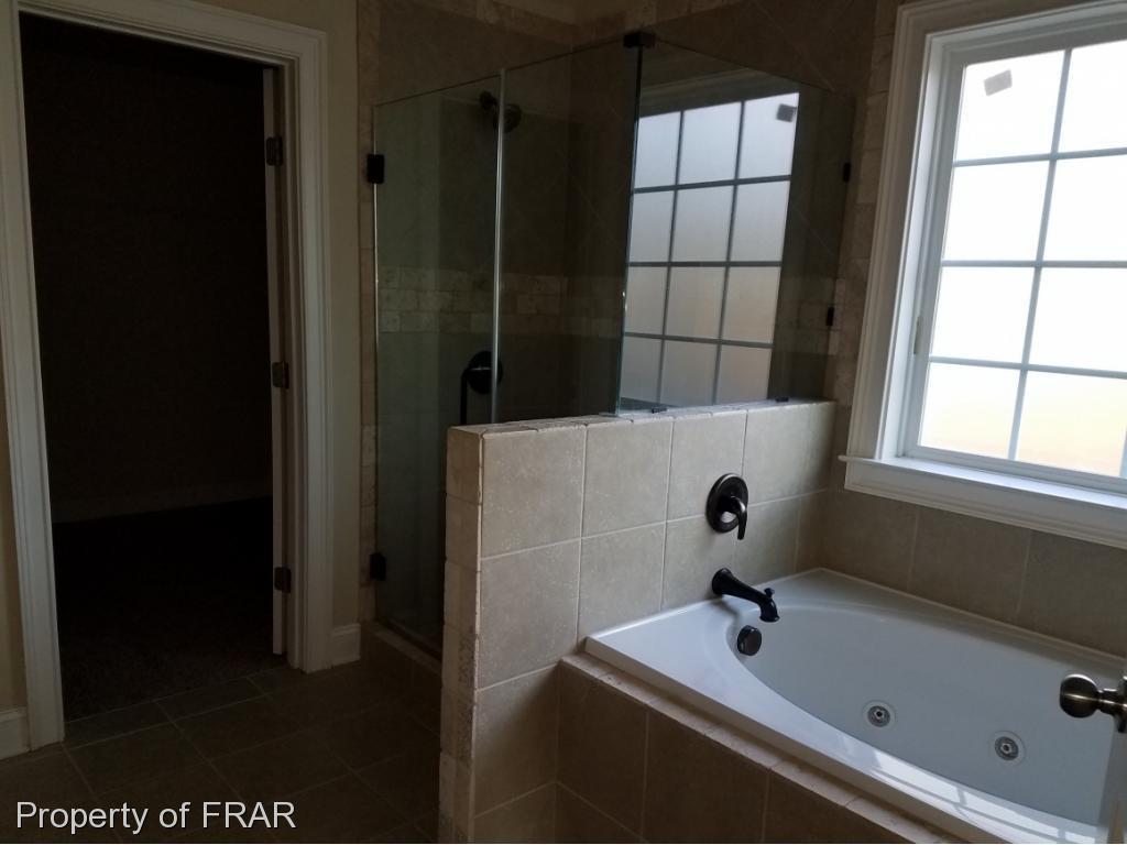 355 Regimental Drive Cameron, NC 28326 - Photo 11 of 19 a bathroom with a tub and a window