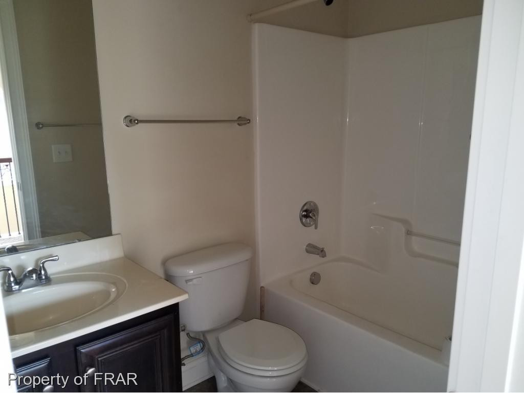 355 Regimental Drive Cameron, NC 28326 - Photo 13 of 19 a bathroom with a sink toilet vanity and shower