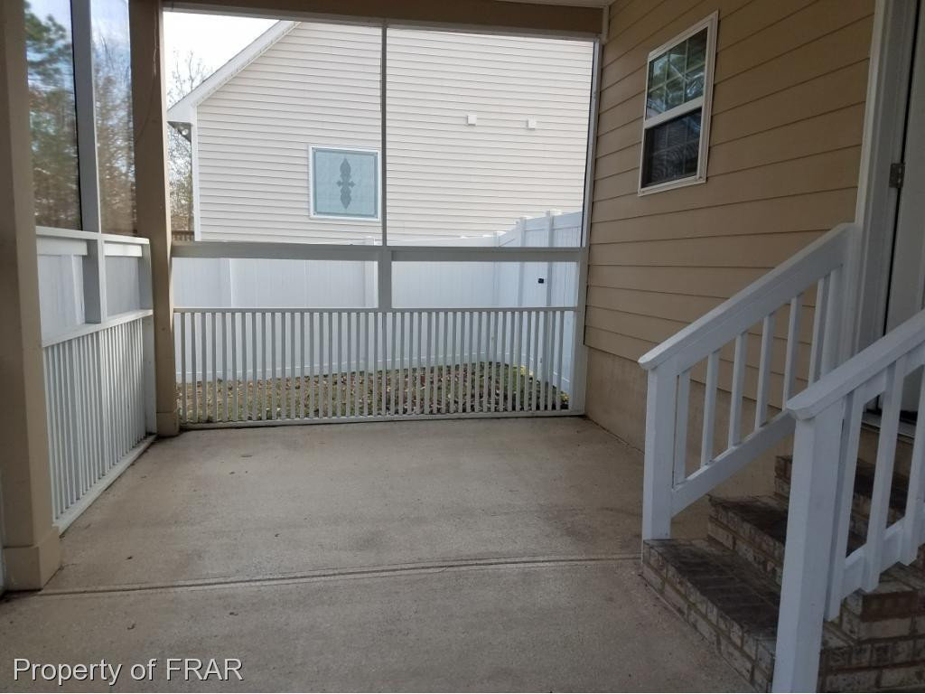 355 Regimental Drive Cameron, NC 28326 - Photo 17 of 19 a view of a house with a small yard and wooden floor and fence
