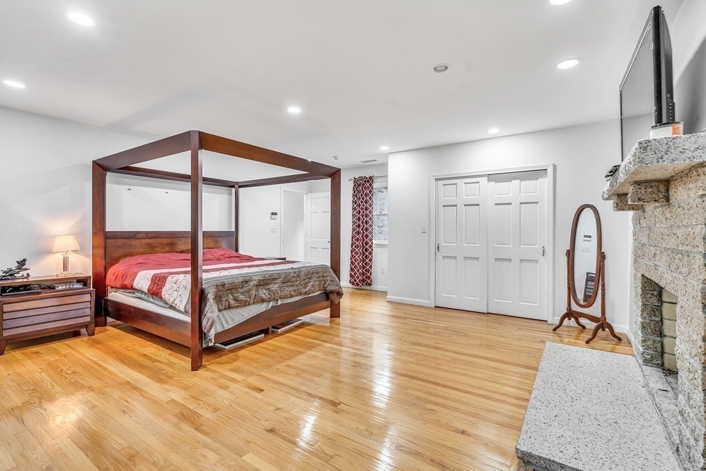 3 Goodnow Road Sudbury, MA 01776 - Photo 13 of 34 a bedroom with a bed and a chandelier