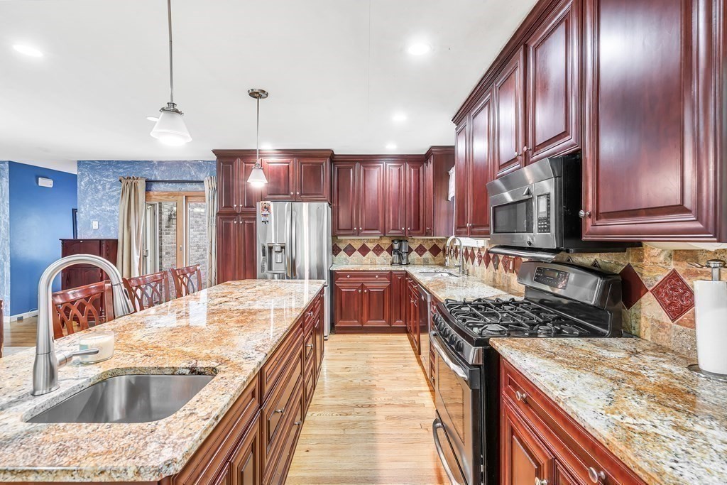 3 Goodnow Road Sudbury, MA 01776 - Photo 6 of 34 a kitchen with stainless steel appliances granite countertop a sink stove and refrigerator