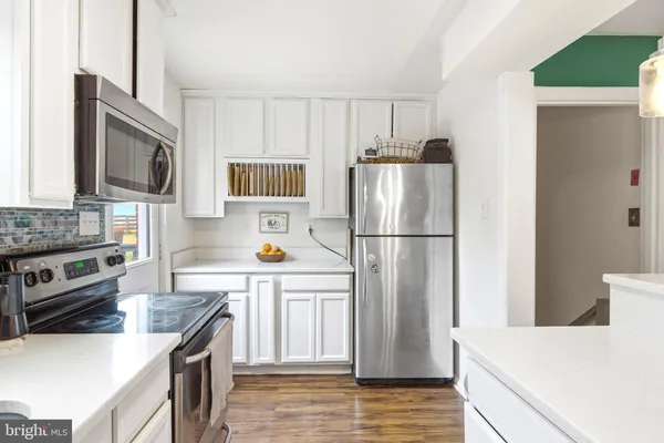 a kitchen with a refrigerator a stove top oven a sink and dishwasher
