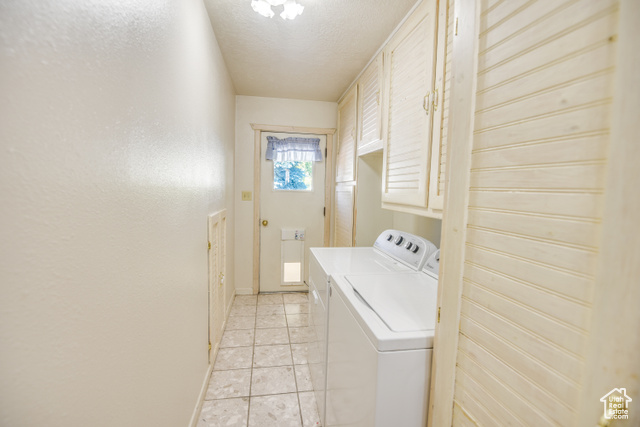 2373 East 190 North Beaver, UT 84713 - Photo 30 of 54 Laundry room with cabinet space, a textured ceiling, washer and clothes dryer, and light tile patterned floors
