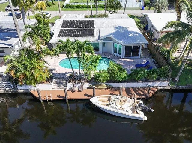 a view of a lake with boats and palm trees